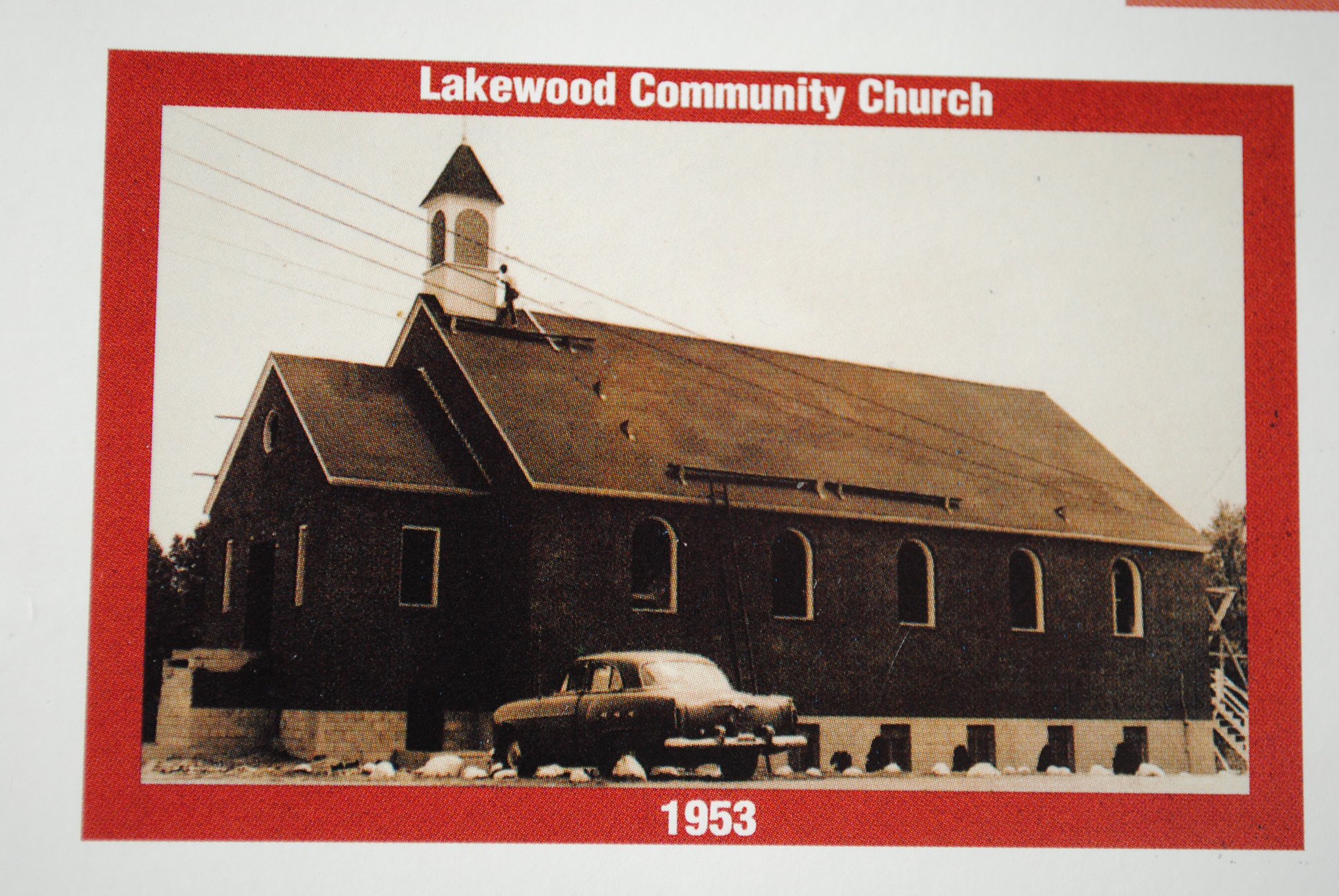 The new Lakewood sanctuary under construction in 1953, with a worker on the roof by the steeple